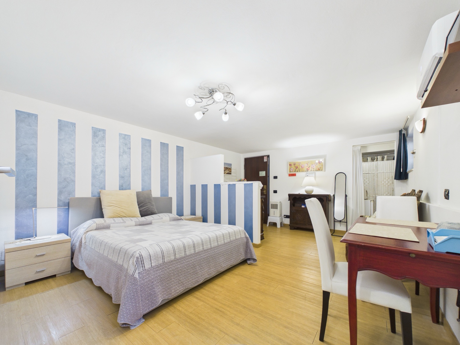 Bedroom with blue striped accent wall
